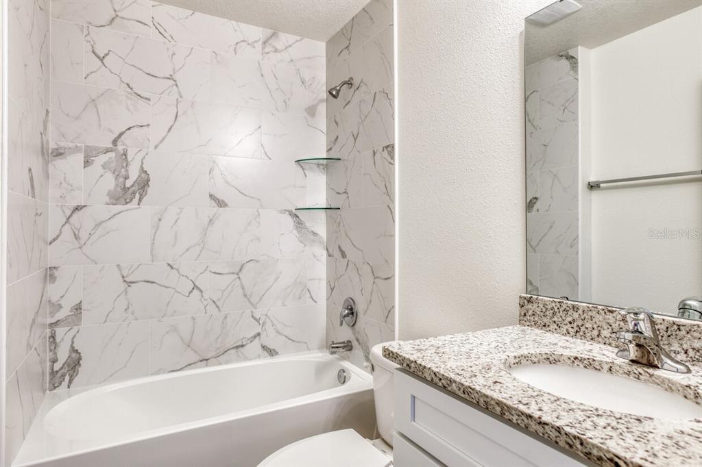 4840 Kenneth Street Hastings, FL 32145 - Photo 13 of 22 a bathroom with a granite countertop sink toilet and shower