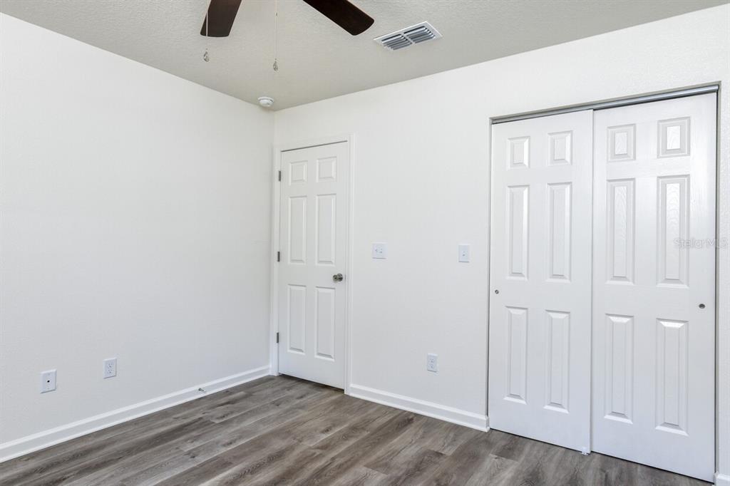 4840 Kenneth Street Hastings, FL 32145 - Photo 14 of 22 an empty room with a ceiling fan