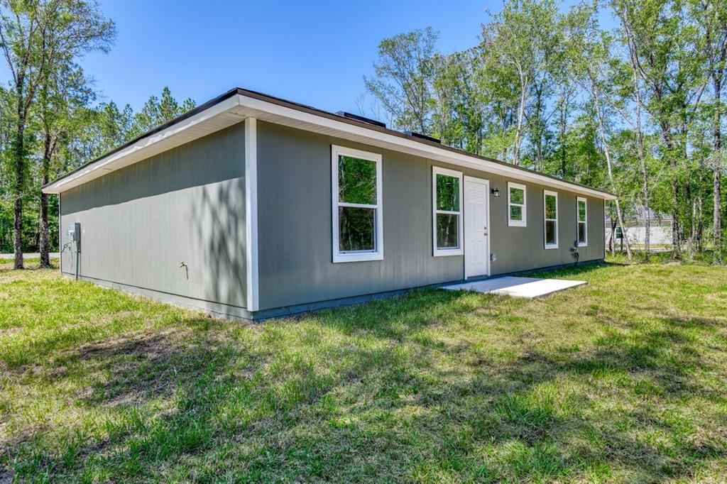 4840 Kenneth Street Hastings, FL 32145 - Photo 18 of 22 a view of a house with a yard