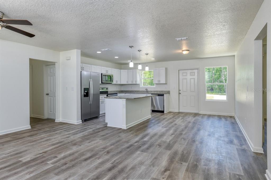 4840 Kenneth Street Hastings, FL 32145 - Photo 2 of 22 a view of kitchen with refrigerator stove microwave and cabinets