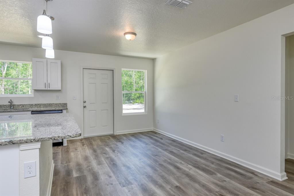 4840 Kenneth Street Hastings, FL 32145 - Photo 4 of 22 an empty room with wooden floor and a window
