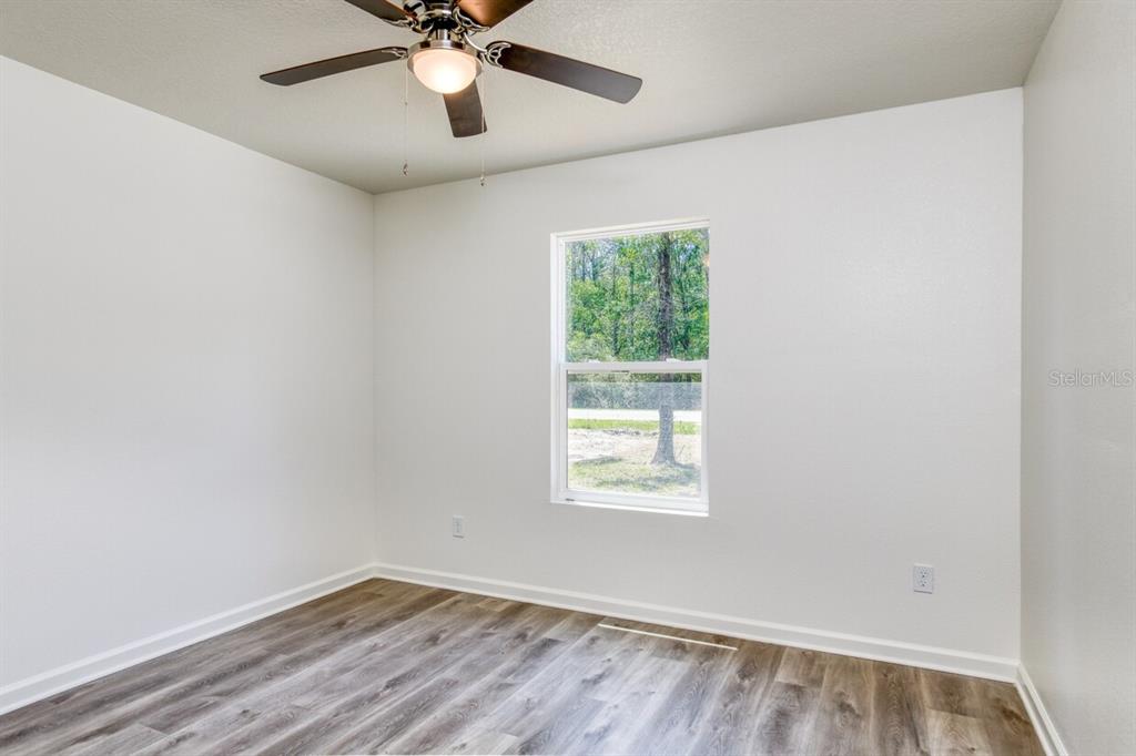 4840 Kenneth Street Hastings, FL 32145 - Photo 5 of 22 an empty room with a window and a fan