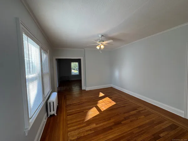 wooden floor in an empty room with a window
