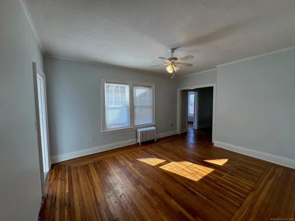 wooden floor in an empty room with a window