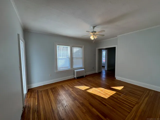 wooden floor in an empty room with a window