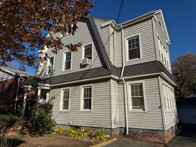 a front view of a house with plants