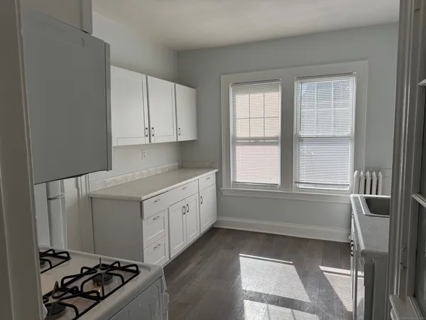 a kitchen with granite countertop a stove and a refrigerator
