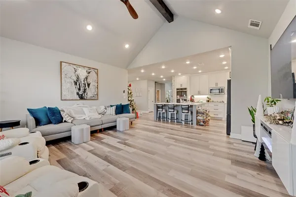 a living room with furniture and kitchen view