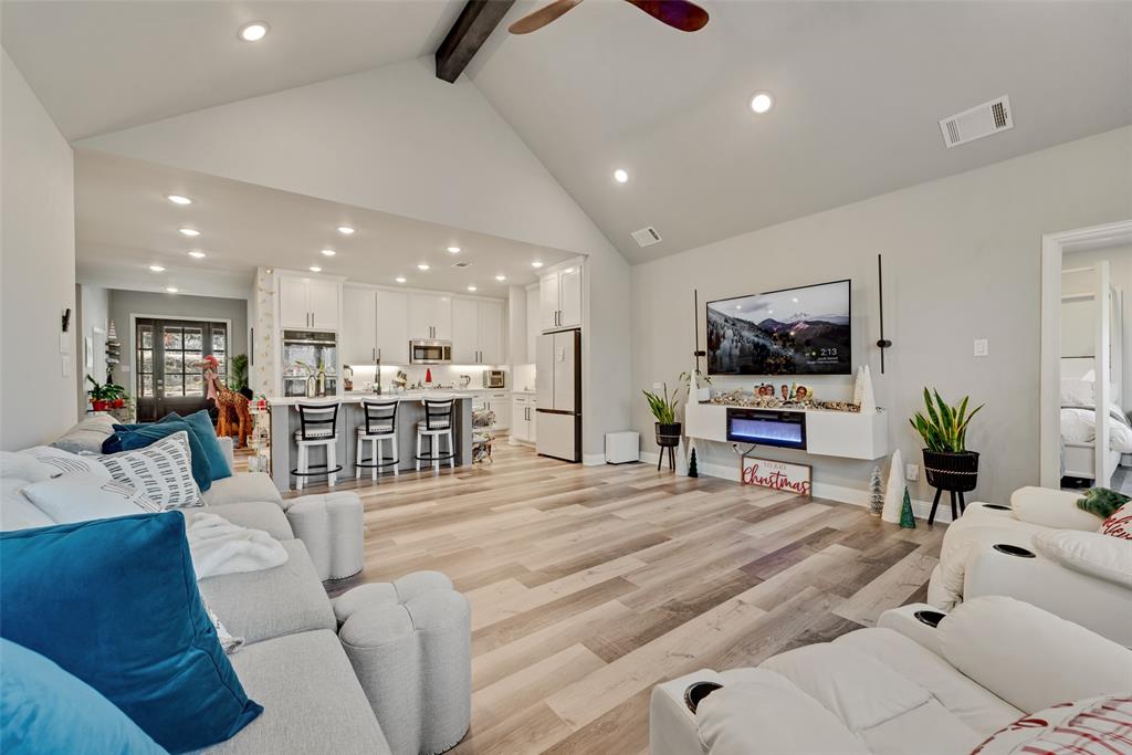 421 Ridgeview Road Sherman, TX 75092 - Photo 13 of 35 a living room with furniture a flat screen tv and kitchen view