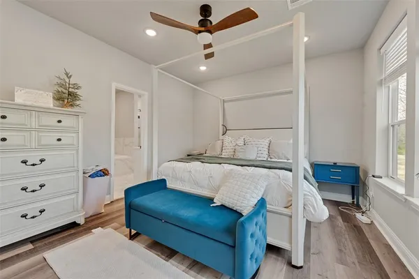 a bedroom with a bed window and a ceiling fan