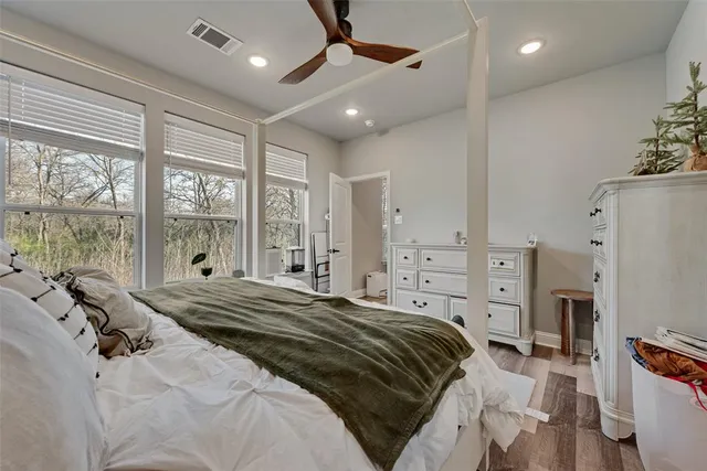 a bedroom with a large bed and a large window