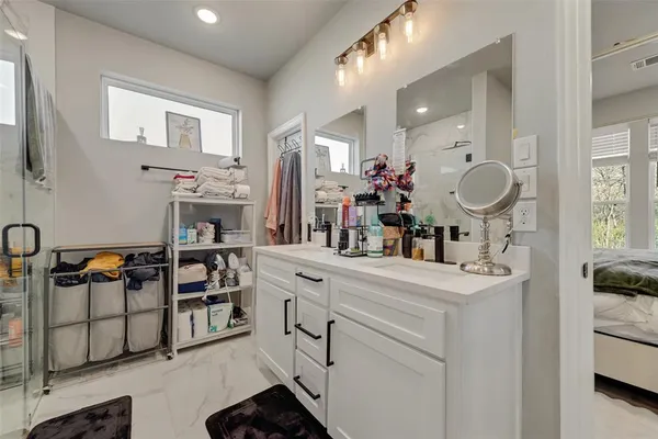 a spacious bathroom with a sink double vanity and a mirror