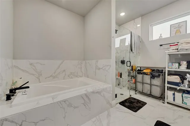 a bathroom with a bathtub and a shower