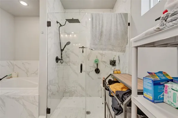 a bathroom with a bathtub and shower