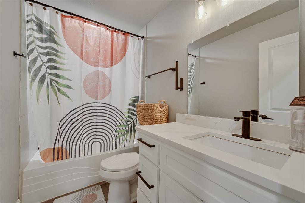 421 Ridgeview Road Sherman, TX 75092 - Photo 29 of 35 a bathroom with a sink a toilet and a mirror