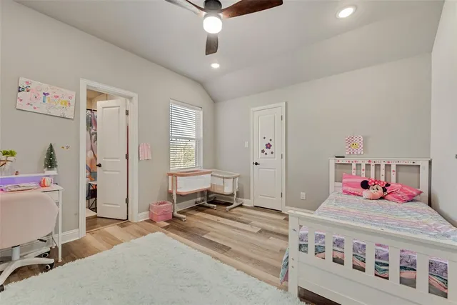 a bedroom with a bed and a desk