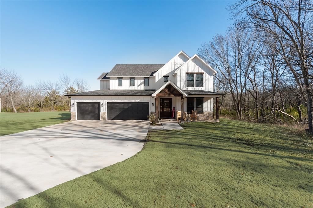 421 Ridgeview Road Sherman, TX 75092 - Photo 3 of 35 a front view of a house with a garden