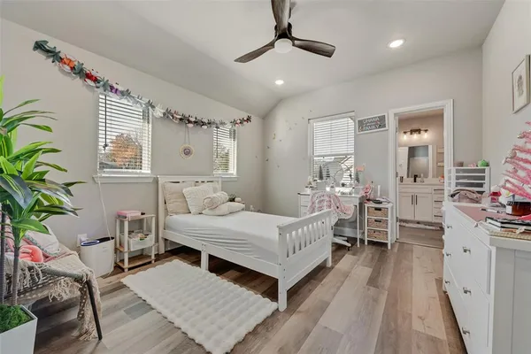 a bedroom with a bed couch and a window