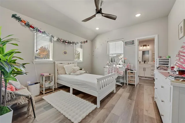 a bedroom with a bed couch and a window