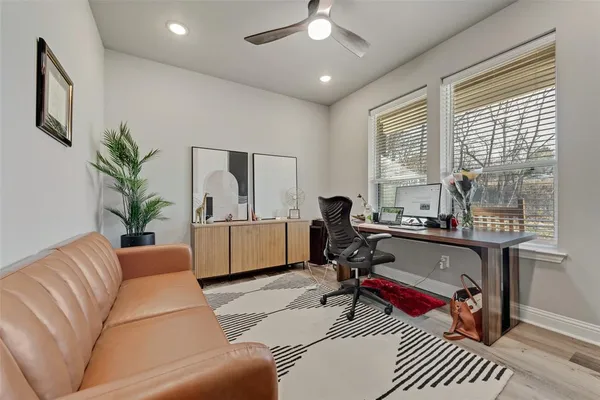 a living room with furniture a window and a potted plant