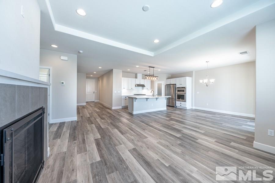 2417 Silver Maple Drive Reno, NV 89521 - Photo 12 of 38 a view of kitchen and kitchen with wooden floor