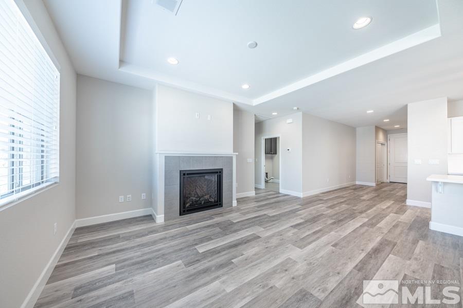2417 Silver Maple Drive Reno, NV 89521 - Photo 13 of 38 a view of empty room with wooden floor and fireplace