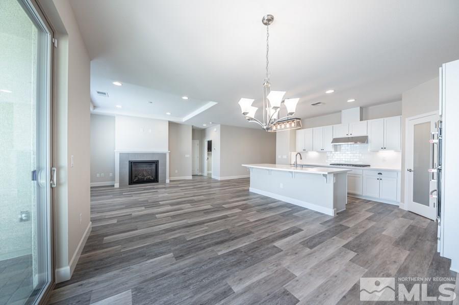 2417 Silver Maple Drive Reno, NV 89521 - Photo 14 of 38 a large kitchen with kitchen island a sink stainless steel appliances and cabinets