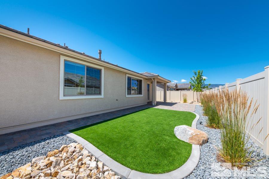 2417 Silver Maple Drive Reno, NV 89521 - Photo 30 of 38 a backyard of a house with table and chairs