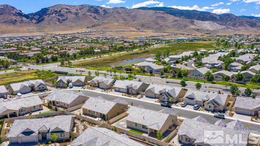 2417 Silver Maple Drive Reno, NV 89521 - Photo 33 of 38 an aerial view of a city with lots of residential buildings and mountain view in back