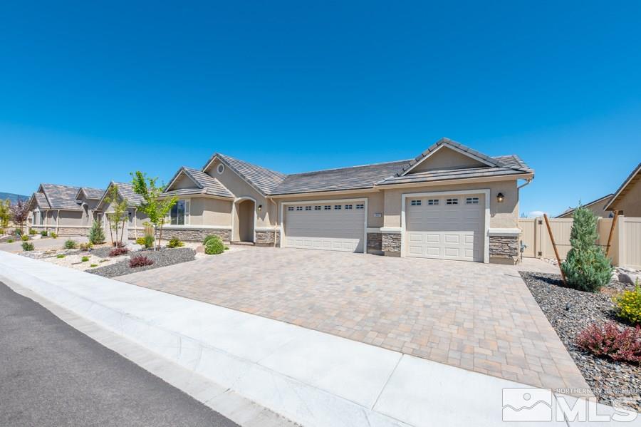 2417 Silver Maple Drive Reno, NV 89521 - Photo 6 of 38 a front view of a house with a yard and garage
