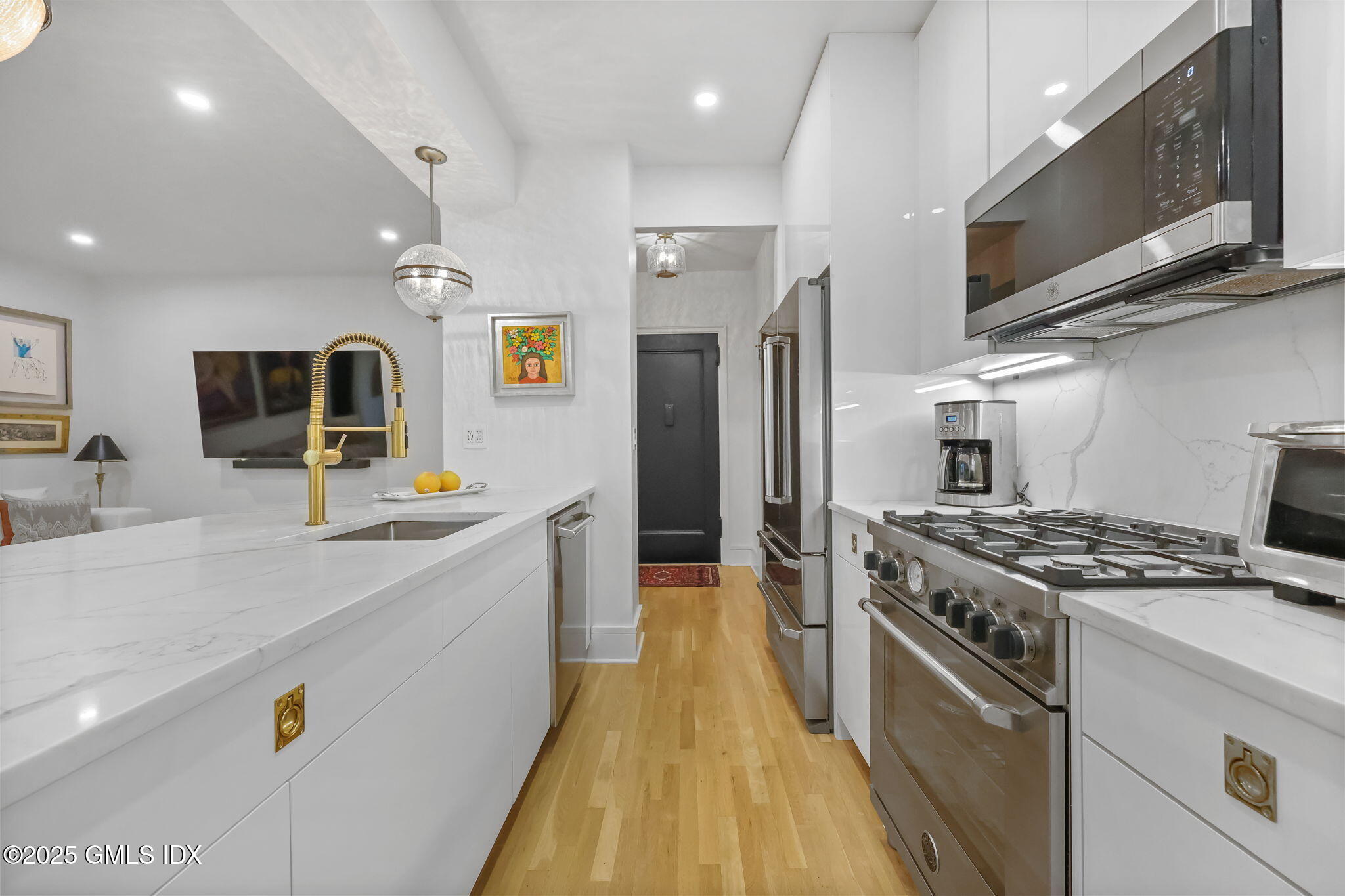 47 Lafayette Place, Unit 1H Greenwich, CT 06830 - Photo 12 of 23 a kitchen with stainless steel appliances granite countertop a stove a sink and a refrigerator
