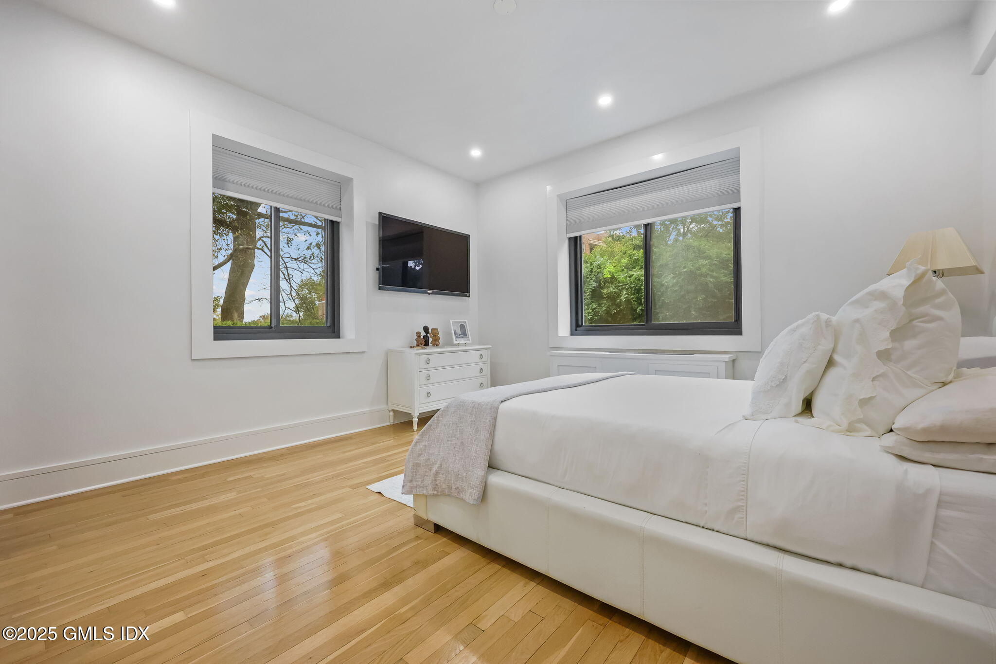 47 Lafayette Place, Unit 1H Greenwich, CT 06830 - Photo 17 of 23 a bedroom with a large bed and a flat screen tv