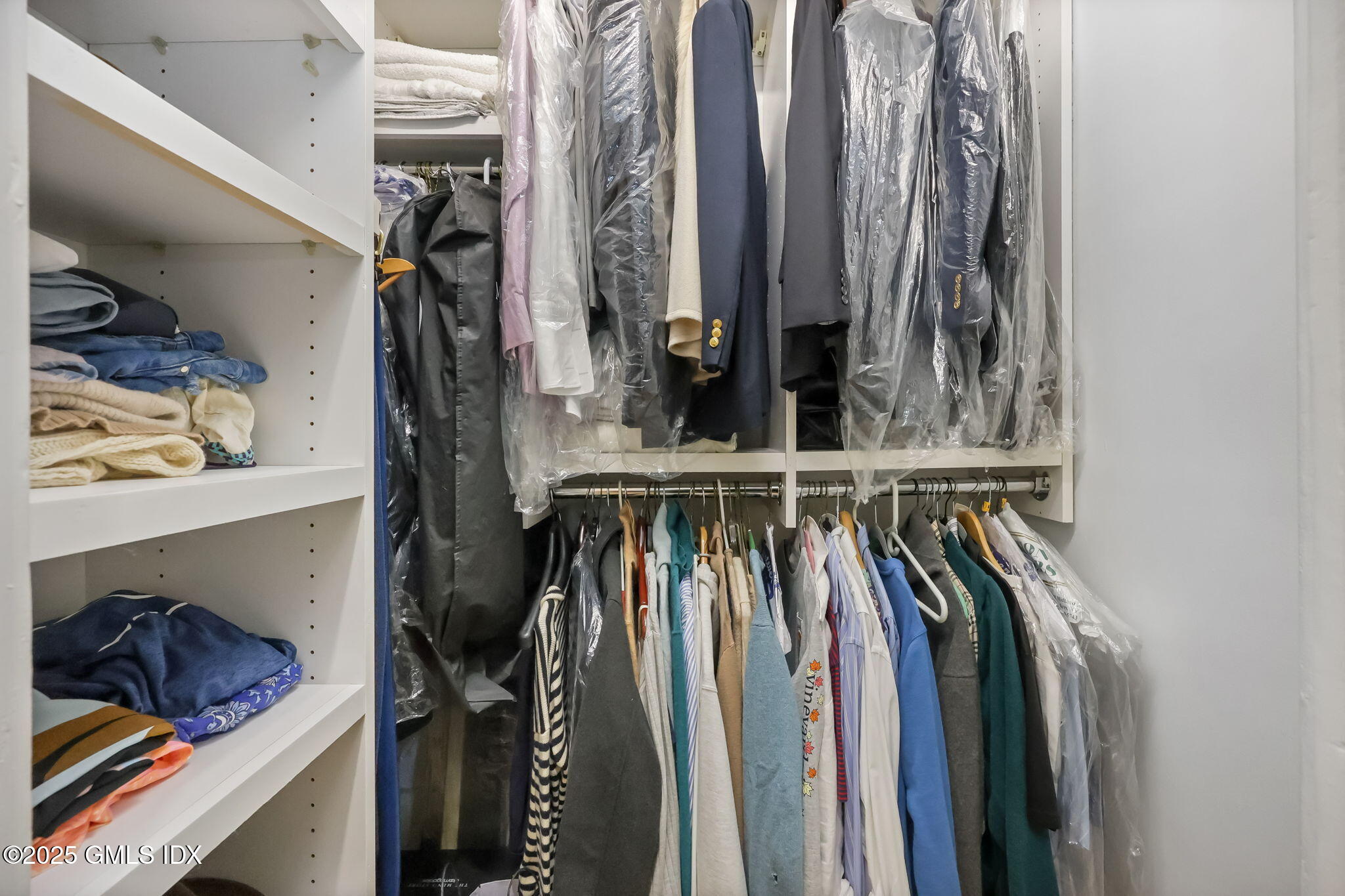 47 Lafayette Place, Unit 1H Greenwich, CT 06830 - Photo 20 of 23 a view of walk in closet with clothes and shoes