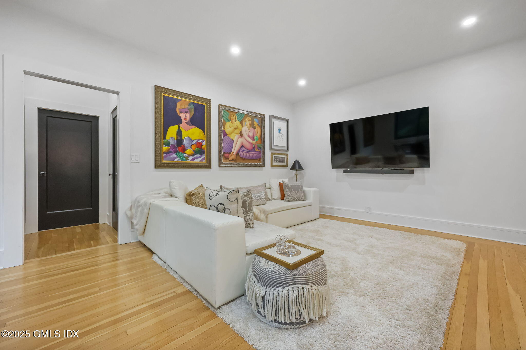 47 Lafayette Place, Unit 1H Greenwich, CT 06830 - Photo 4 of 23 a living room with furniture and a flat screen tv