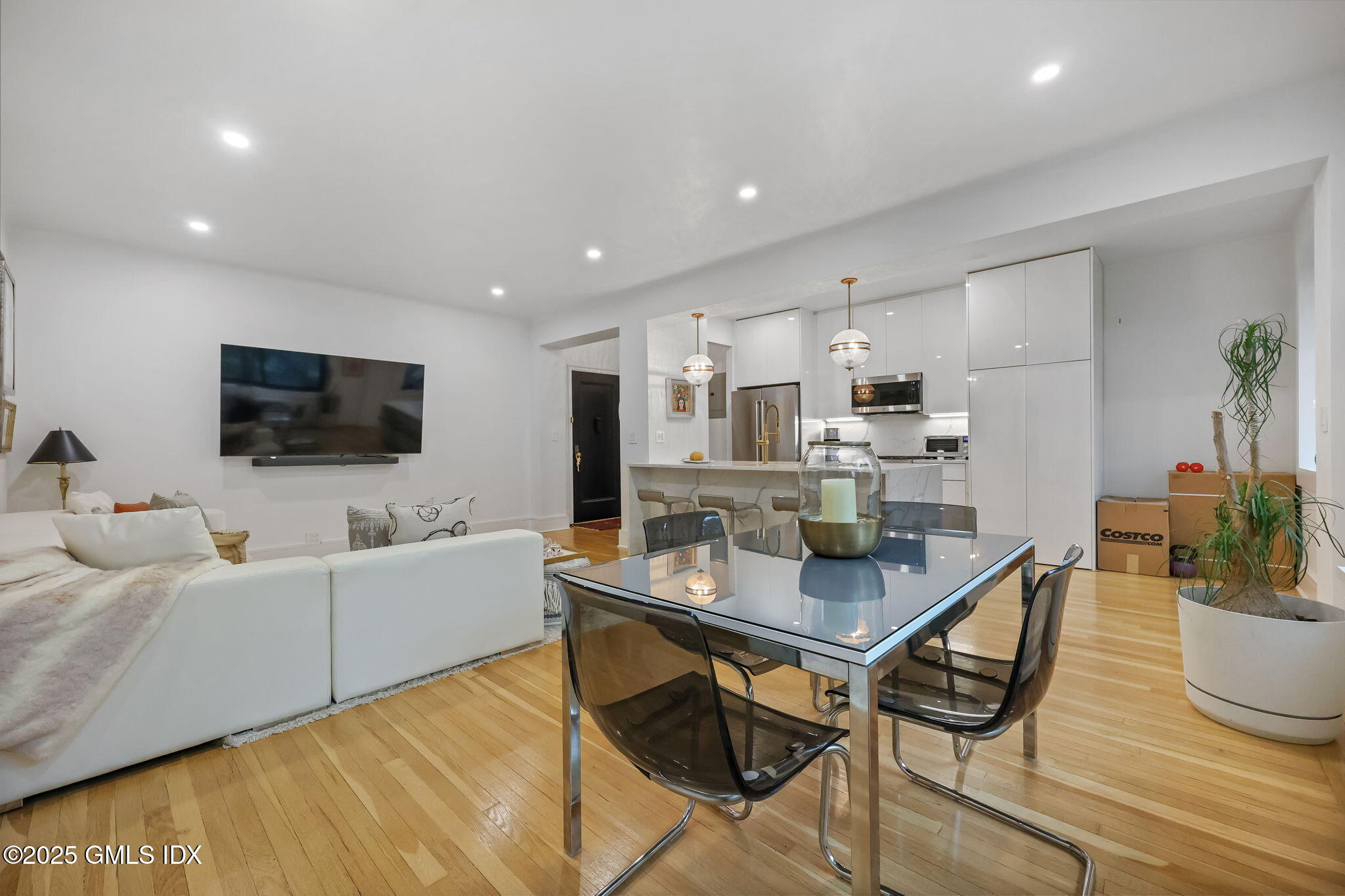 47 Lafayette Place, Unit 1H Greenwich, CT 06830 - Photo 6 of 23 a living room with furniture and a flat screen tv