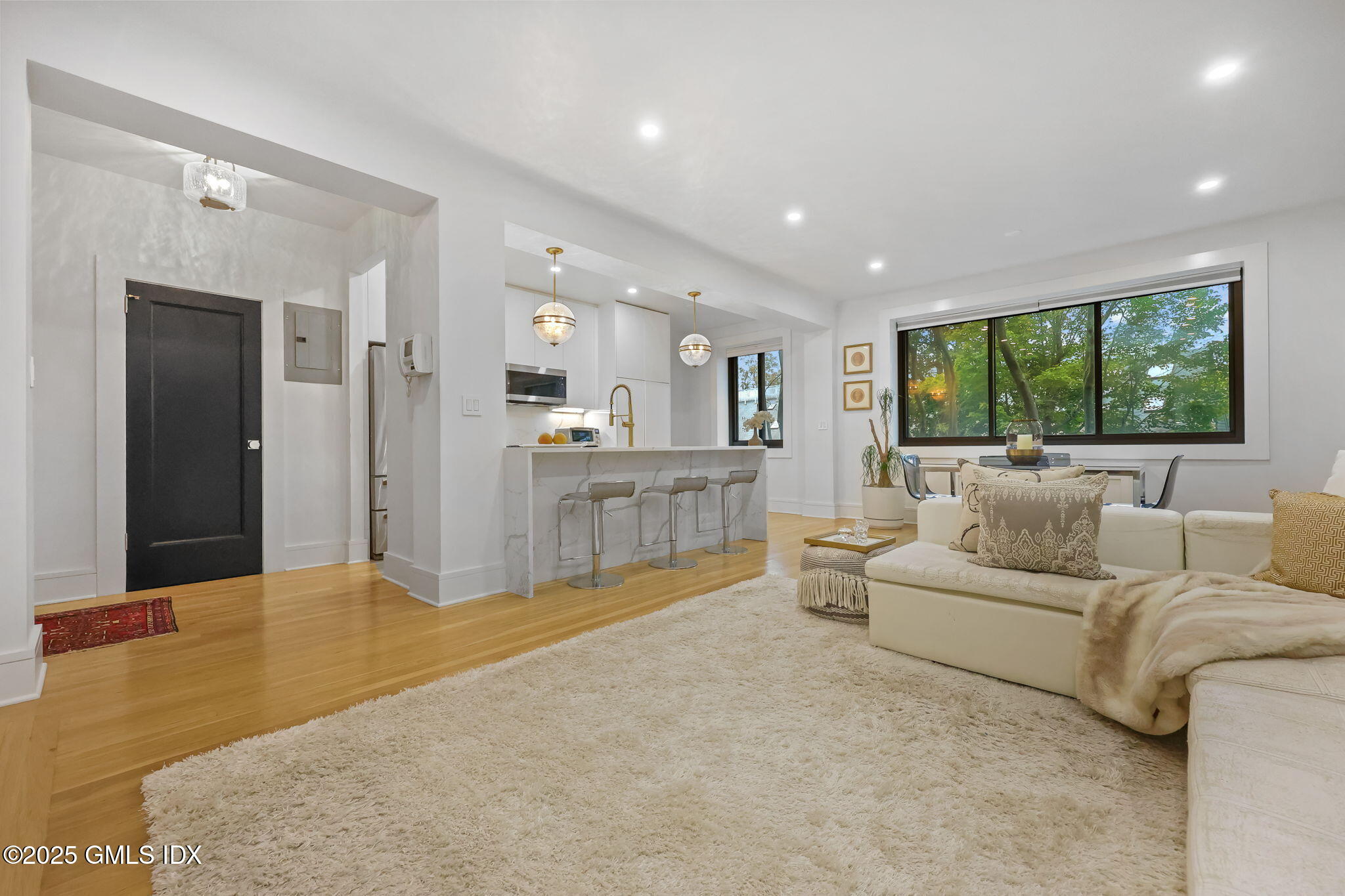 47 Lafayette Place, Unit 1H Greenwich, CT 06830 - Photo 8 of 23 a living room with furniture and a large window