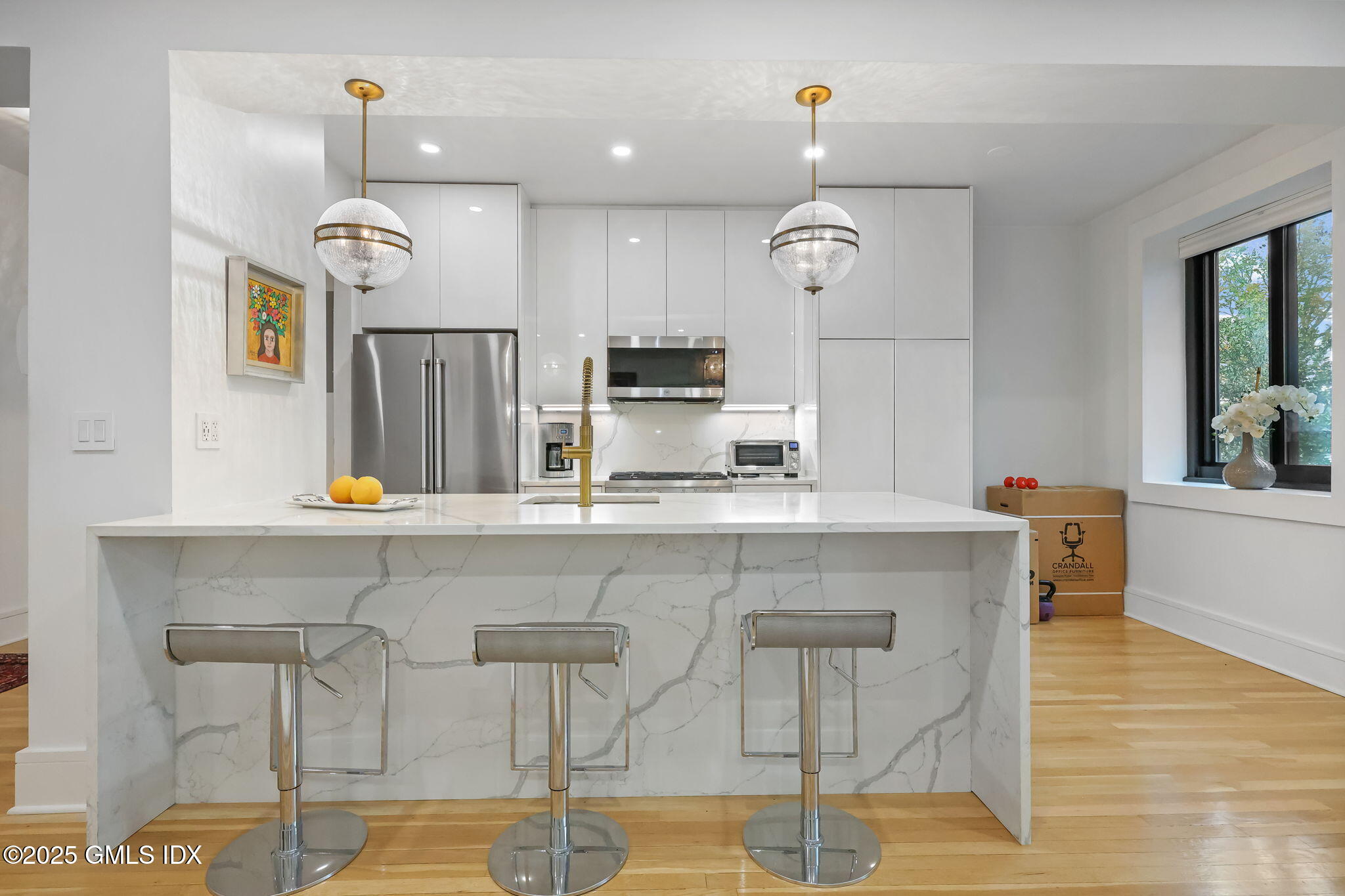 47 Lafayette Place, Unit 1H Greenwich, CT 06830 - Photo 10 of 23 a kitchen with cabinets and chairs