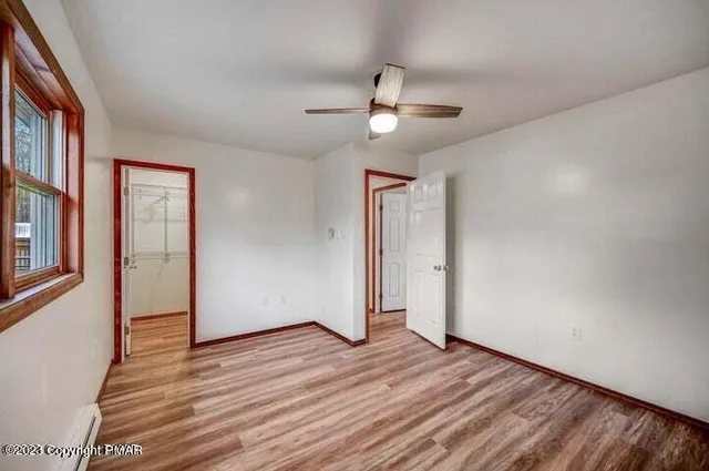 wooden floor in an empty room with a window