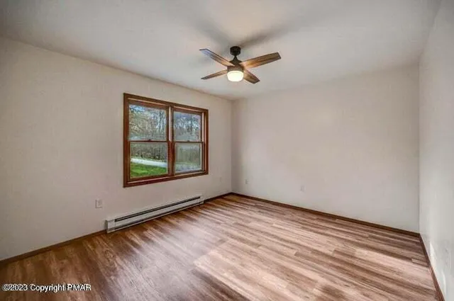 wooden floor in an empty room with a window