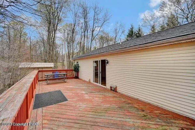 a view of balcony with wooden floor and fence