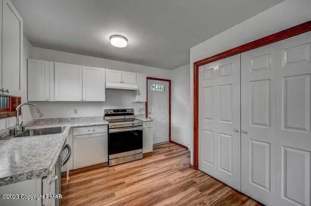 a view of a room with wooden floor
