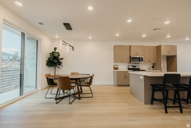 2759 Becco Trail, Unit 16 St. George, UT 84770 - Photo 14 of 42 Kitchen with hanging light fixtures, light wood-type flooring, a breakfast bar, recessed lighting, and modern cabinets