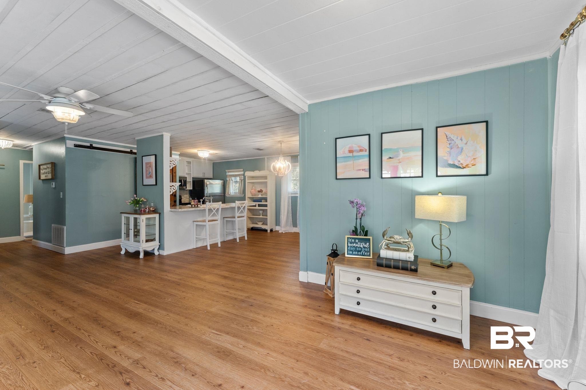 3881 Oregon Avenue Coden, AL 36523 - Photo 15 of 19 Living room featuring a barn door, beam ceiling, light wood finished floors, and a ceiling fan