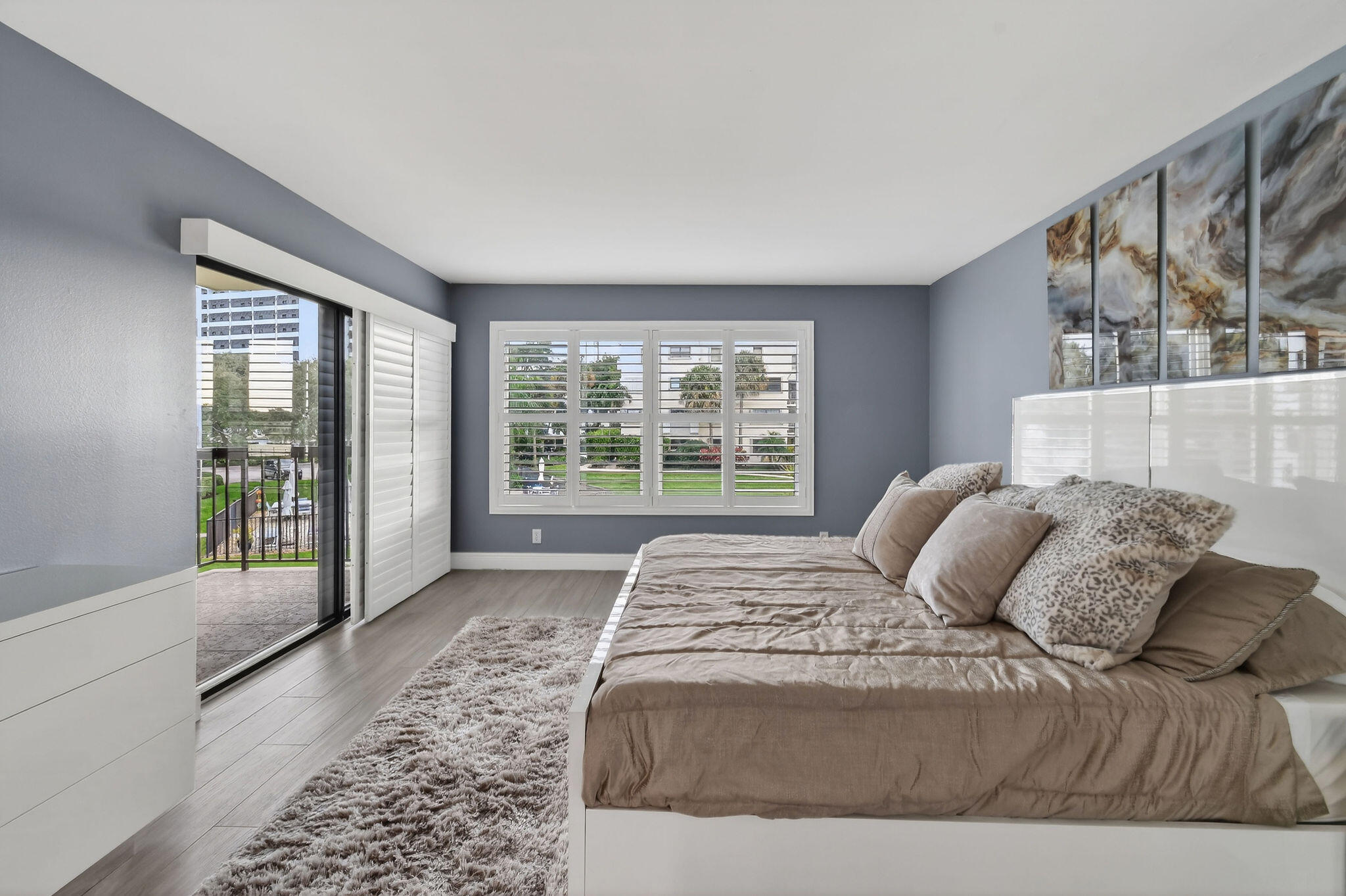 372 Golfview Road, Unit 201 North Palm Beach, FL 33408 - Photo 16 of 45 a large bedroom with a large bed and a couch