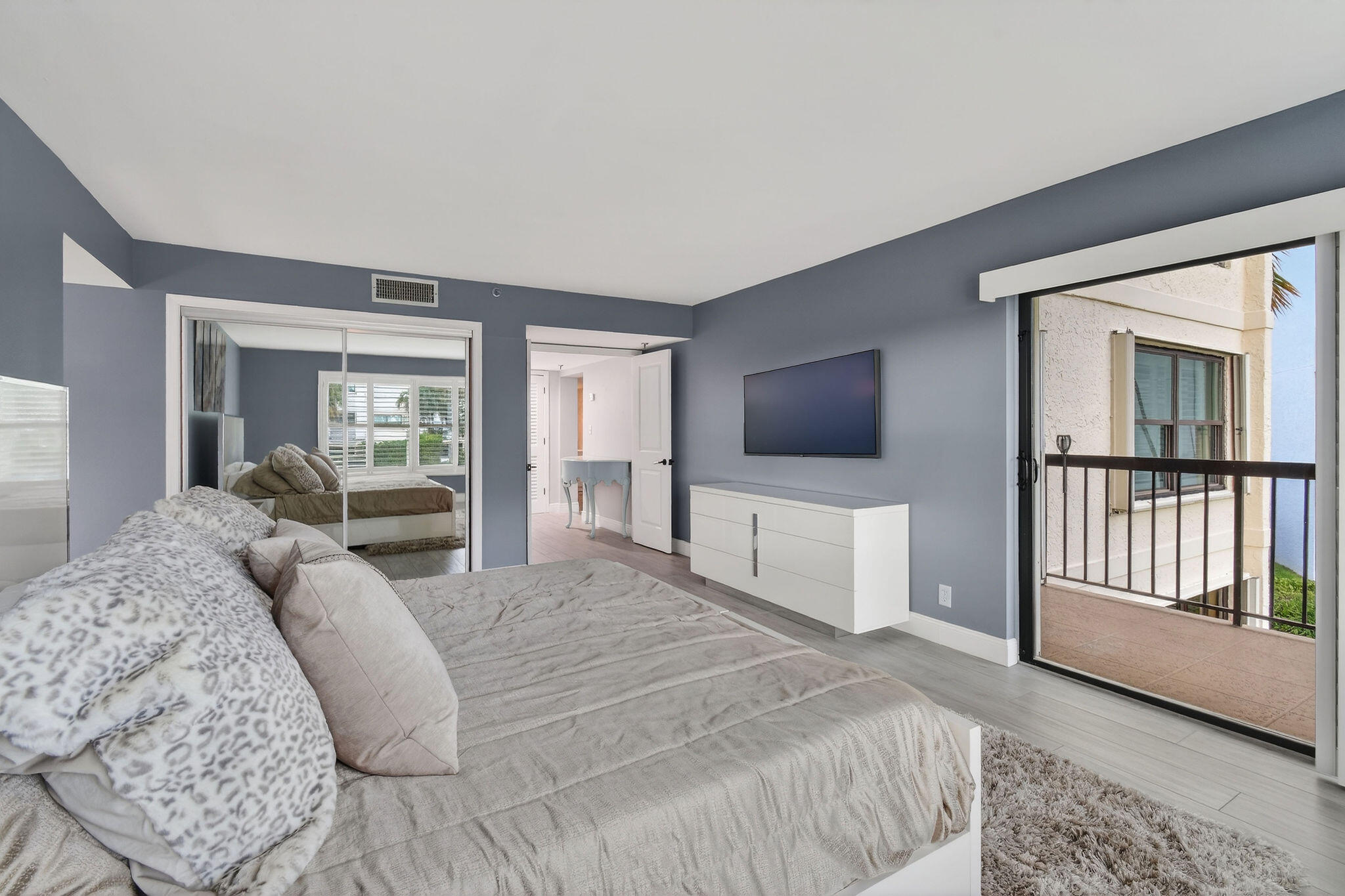 372 Golfview Road, Unit 201 North Palm Beach, FL 33408 - Photo 18 of 45 a bedroom with a large bed and a flat screen tv