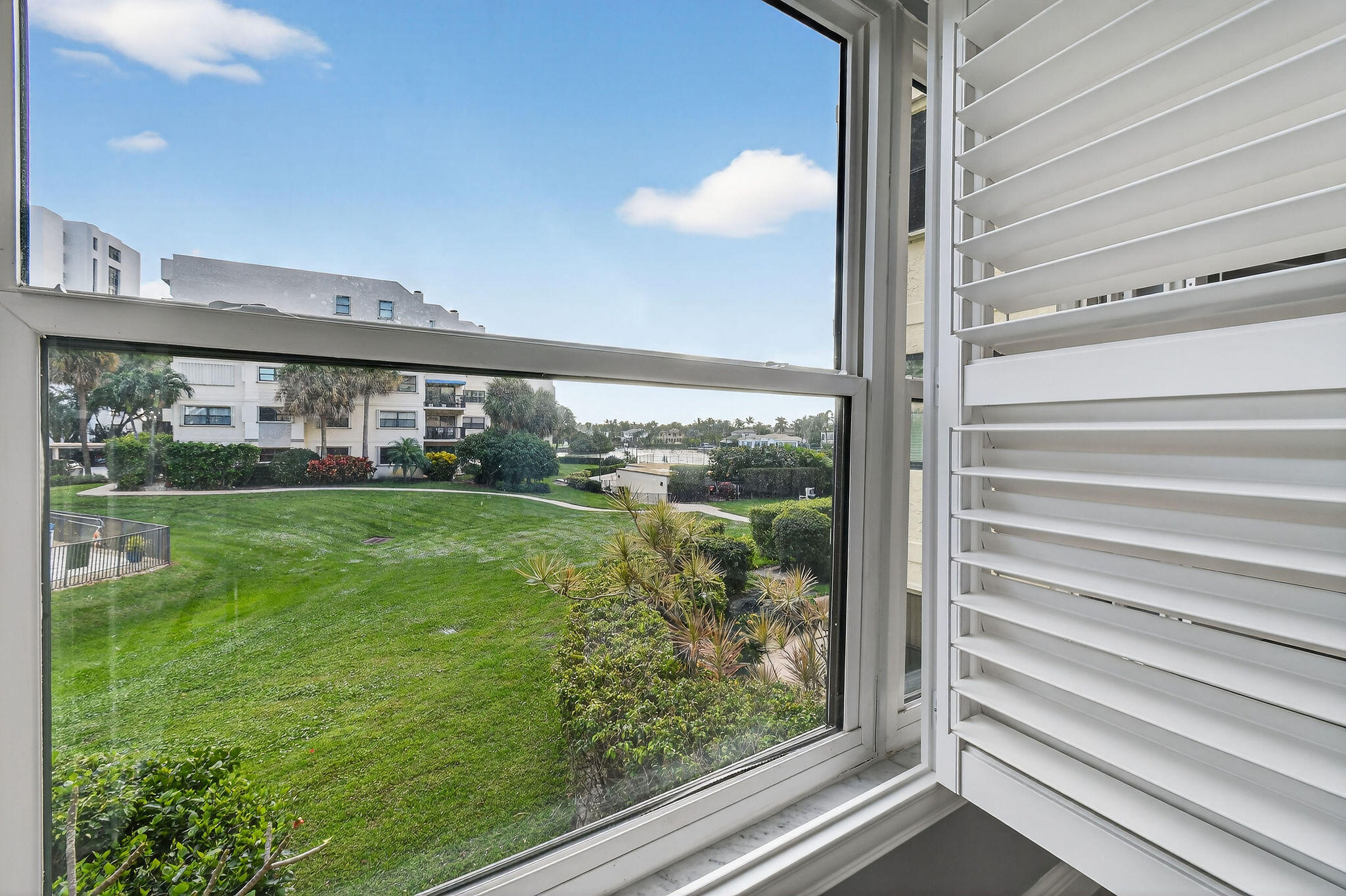 372 Golfview Road, Unit 201 North Palm Beach, FL 33408 - Photo 19 of 45 a view of a house with a yard from a window