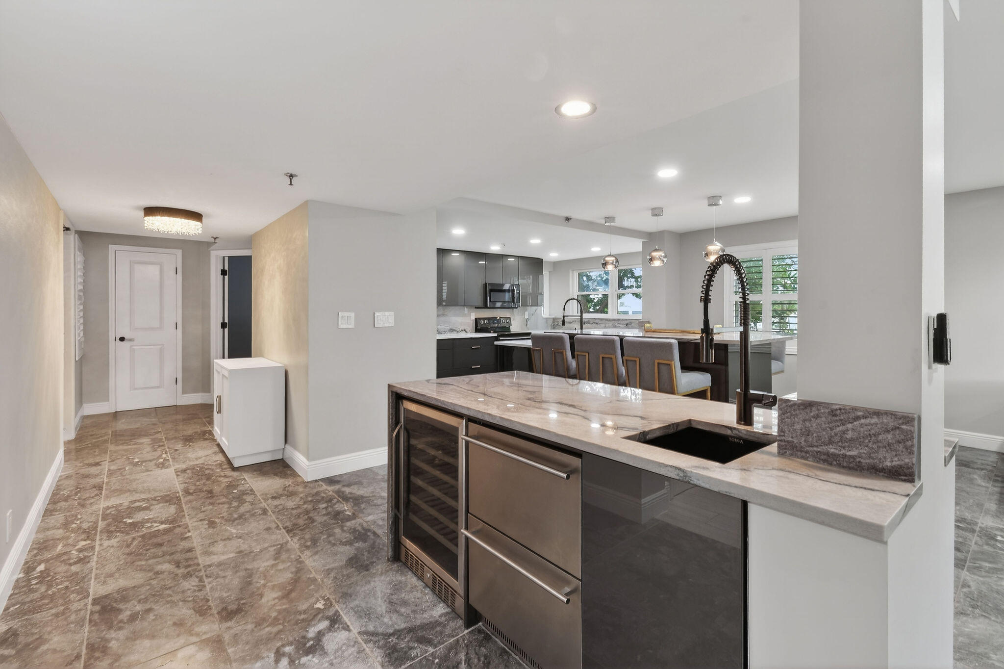 372 Golfview Road, Unit 201 North Palm Beach, FL 33408 - Photo 4 of 45 a kitchen with stainless steel appliances granite countertop a sink and a refrigerator