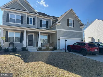 a front view of a house with parking space