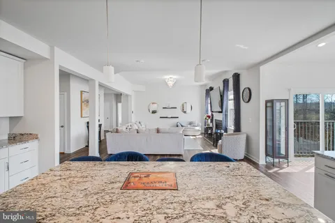 a living room with furniture a bookshelf and a potted plant