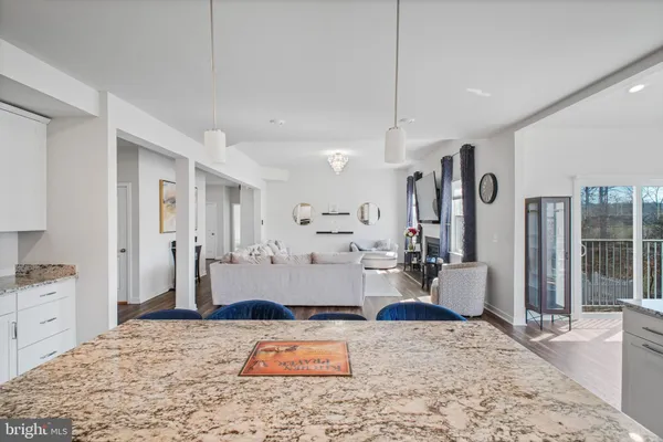 a living room with furniture a bookshelf and a potted plant